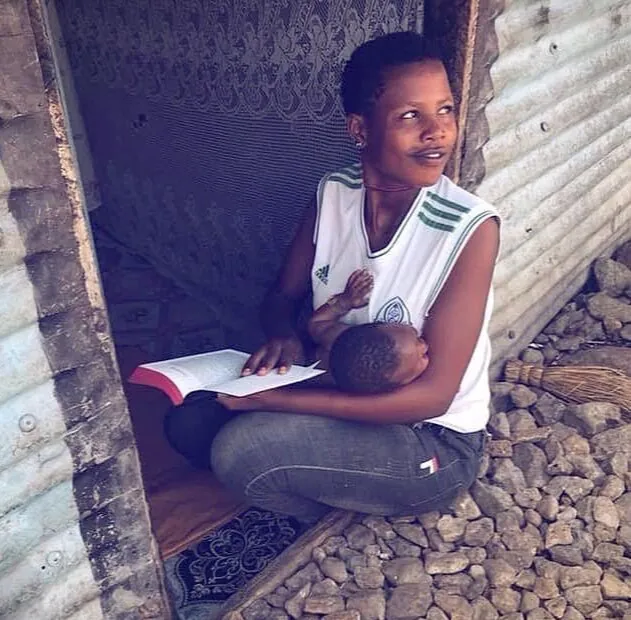 A person reading a resource outdoors